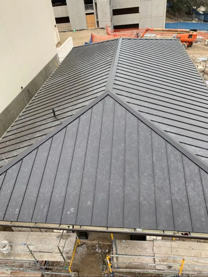 Commercial metal roof construction with crane equipment in Albemarle